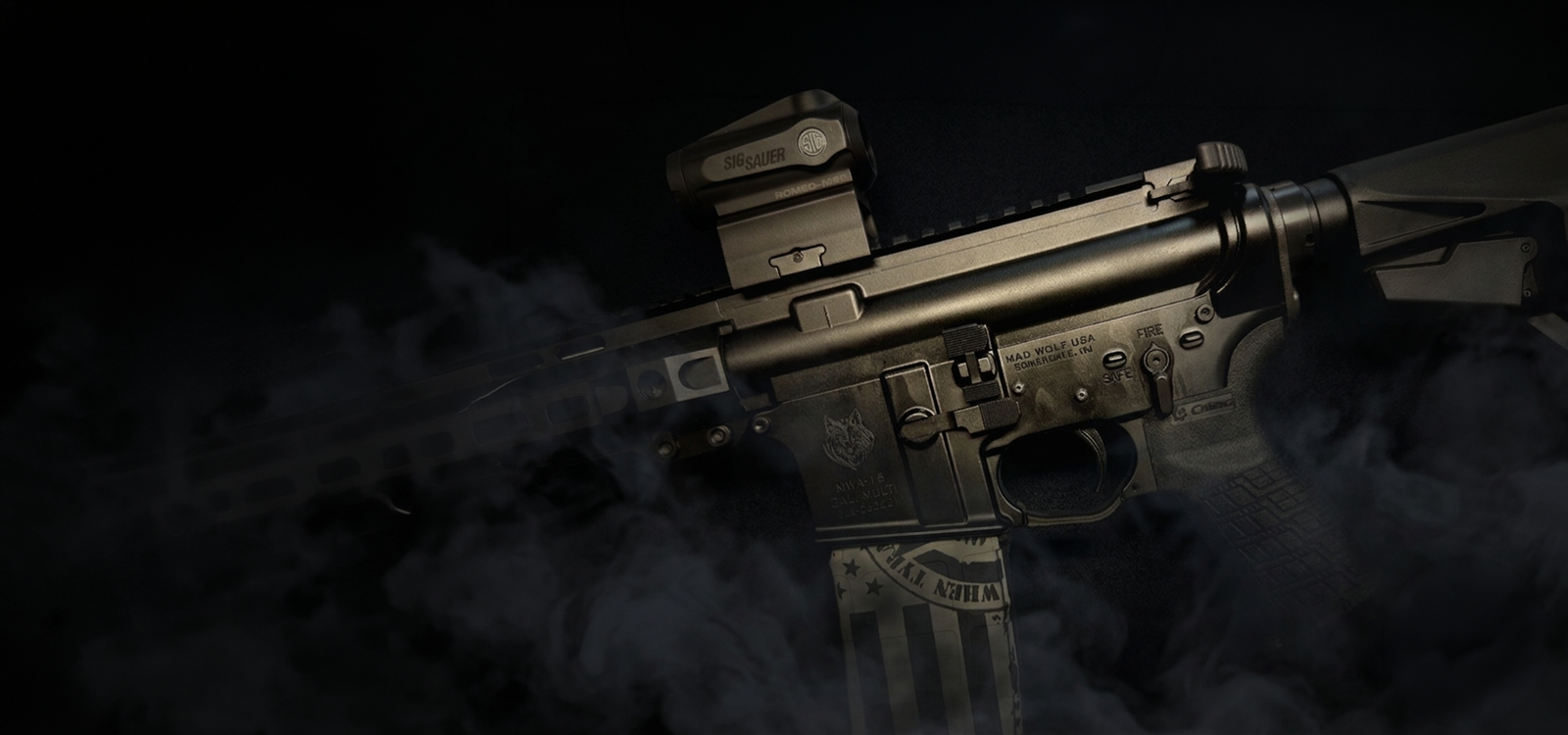 Mad Wolf Armory | Guns, Ammo, Accessories, Custom Firearms A close-up shot of a custom black Mad Wolf Armory tactical rifle with a smoky background background.